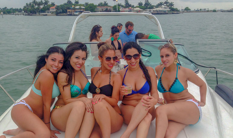 The girls pose for a photo on the bow of the White Ice yacht. 