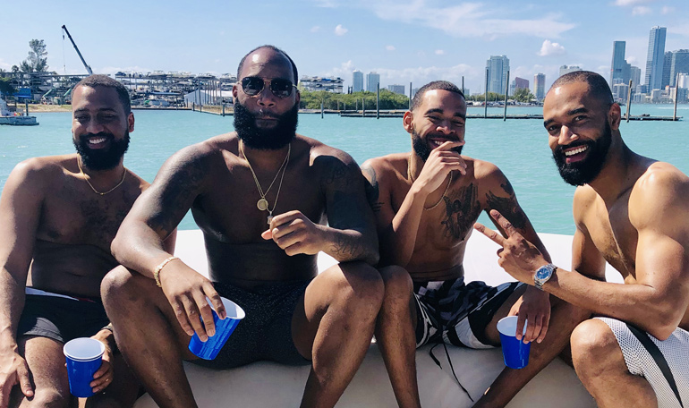 A couple of guys enjoy the sun while renting the Black Ice yacht.